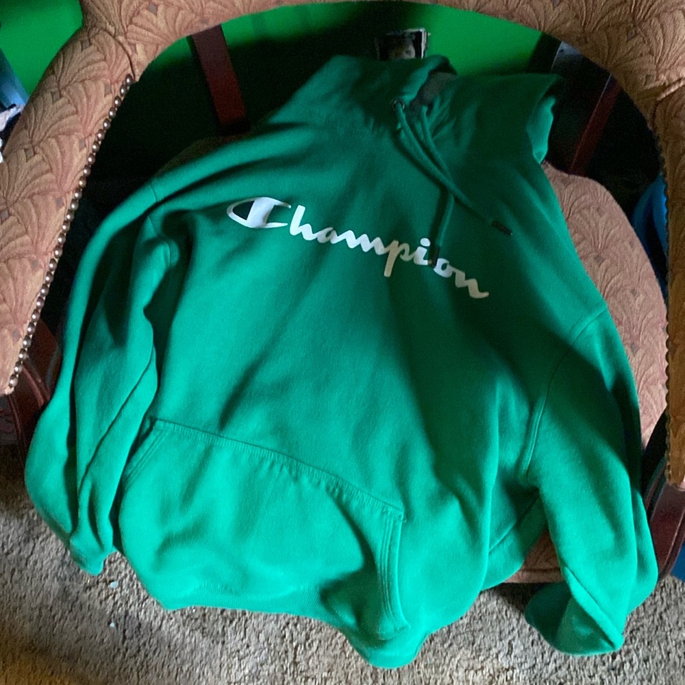 A green and white champion hoodie size medium